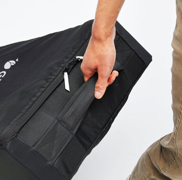 Person pulling the handle of the Roam Padded Roller Backpack